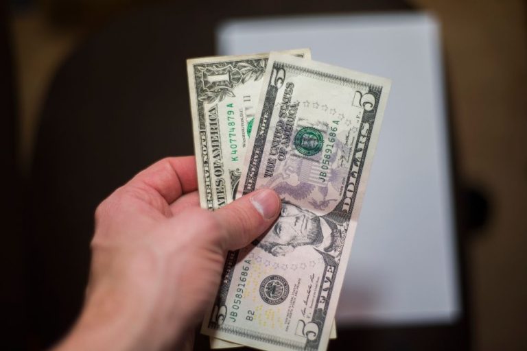 Dollar weakens on reports of Trump team considering gradual tariffs